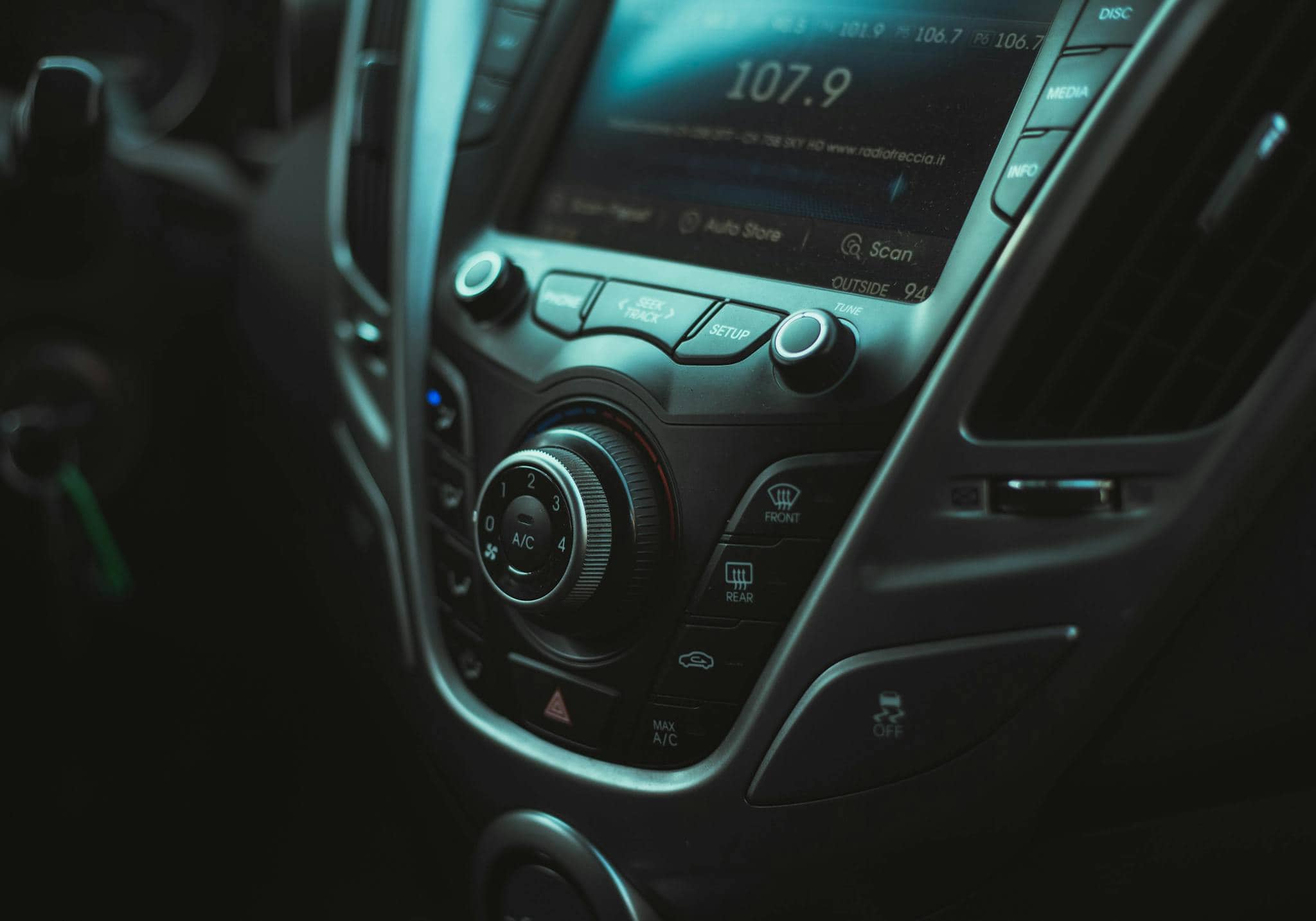 Detailed image of a car's dashboard with visible controls and air vent.