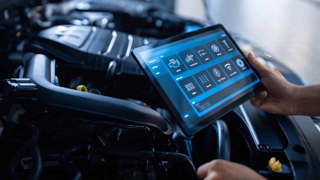 Modern car diagnostic with digital tablet at auto shop.